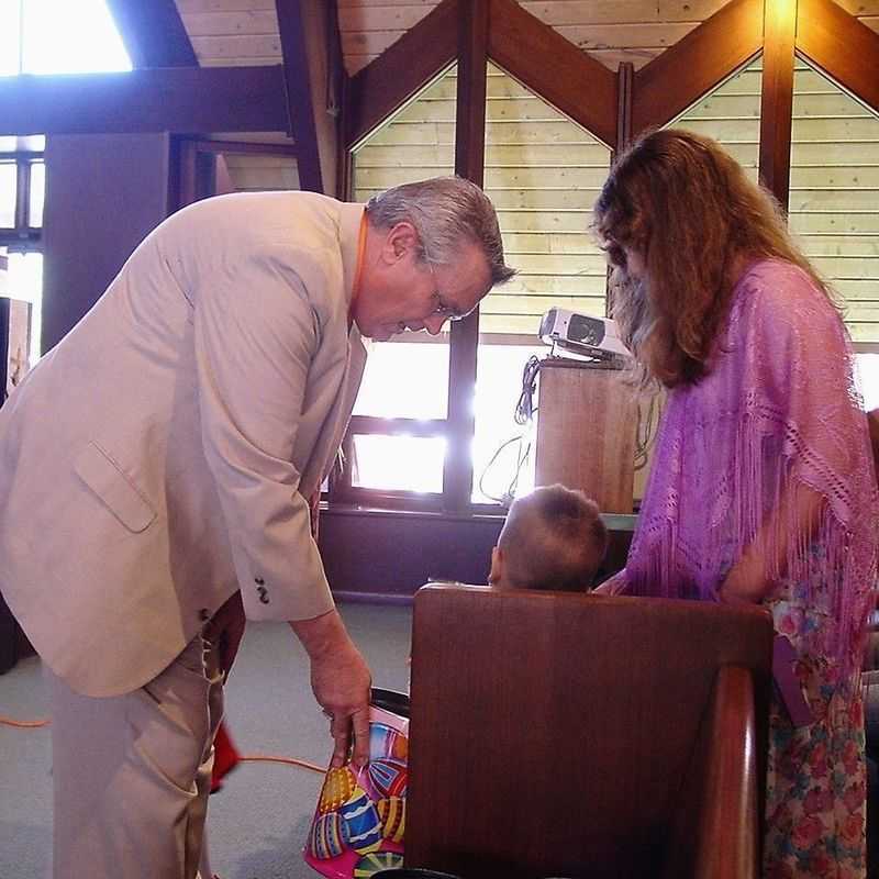 Rev. Sterling Lentz helps kids collect Noisy Offering