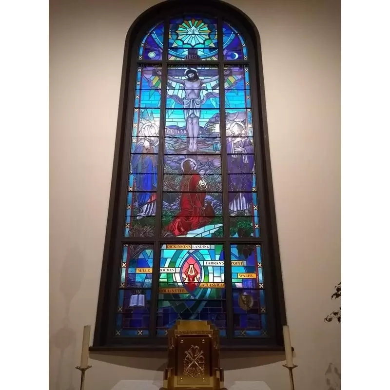 Inside Our Lady - The stained glass behind the altar with a memorial to the Lost Villages