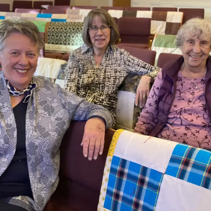 The Comfort Makers, our quilting group, show off their handiwork.