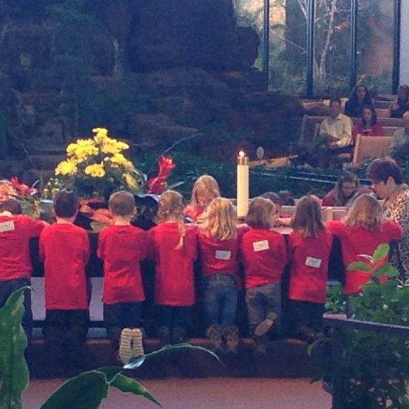 WOW Kids singing and praying in service