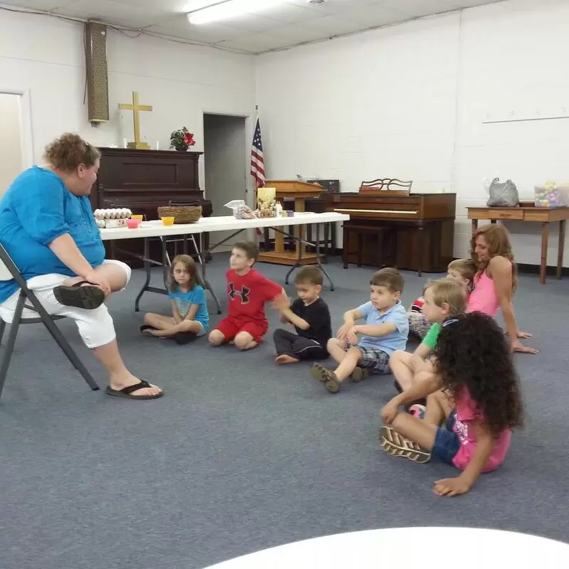 Mrs. Melissa teaching the children the difference between an Easter egg and the empty tomb!