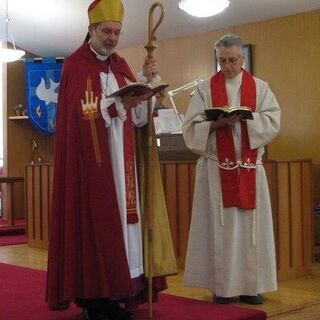 Bishop Derek Hoskin serves Holy Communion at St. Edmund's