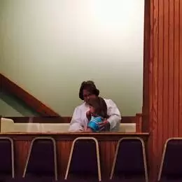 Pastor Carol baptizing Marion by immersion