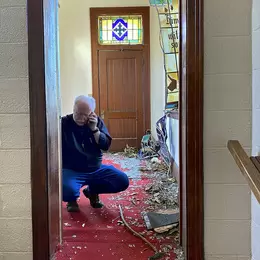 Father Greg Proctor surveys damage in the church’s sanctuary on March 26, 2023 - photo courtesy of Maya Miller, Gulf States Newsroom